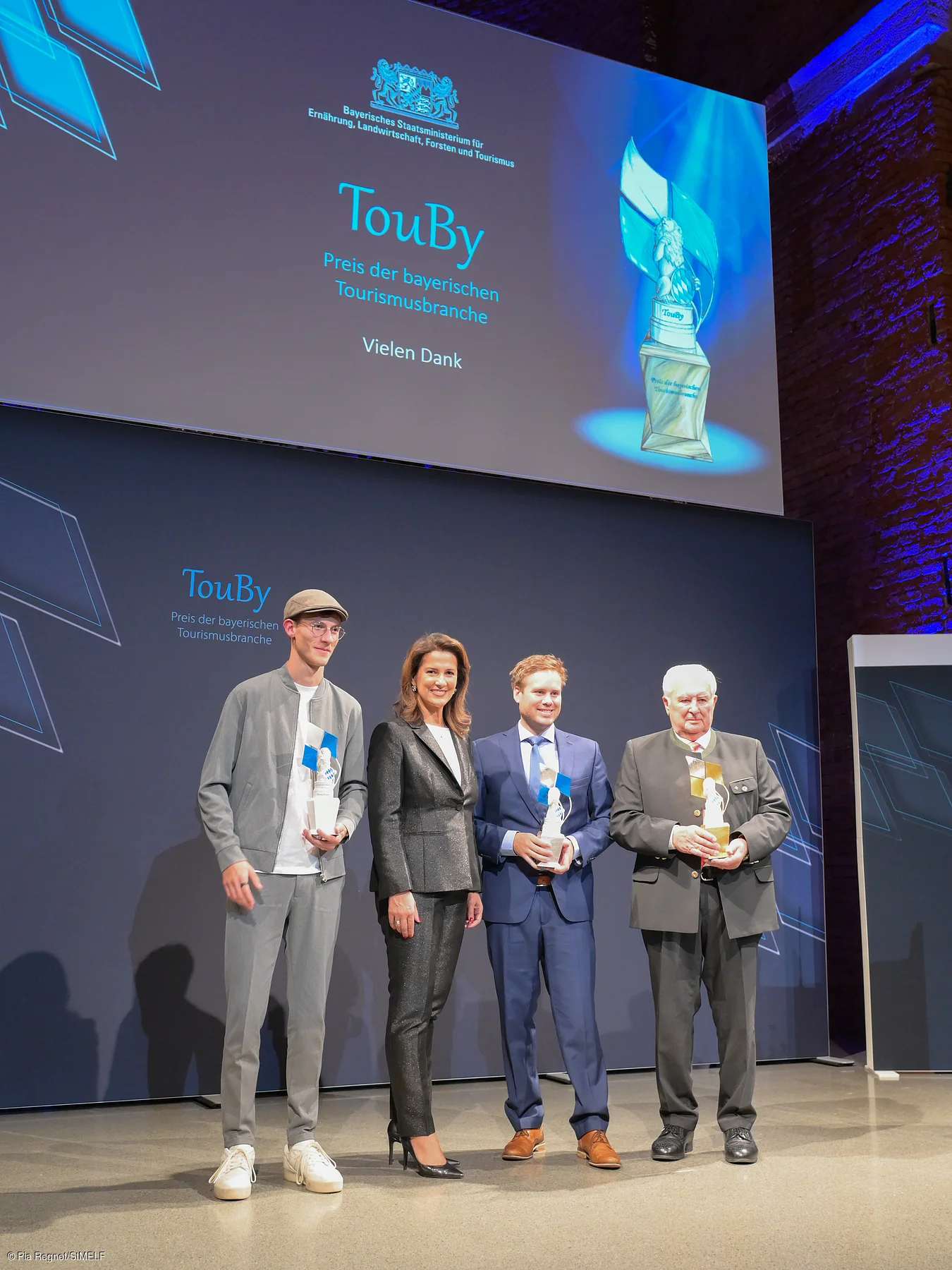 Staatsministerin Michaela Kaniber und die Preisträger des TouBy 2025 (v.l.) Marc-André Janz, Daniel Weickel sowie Karl Zettl.